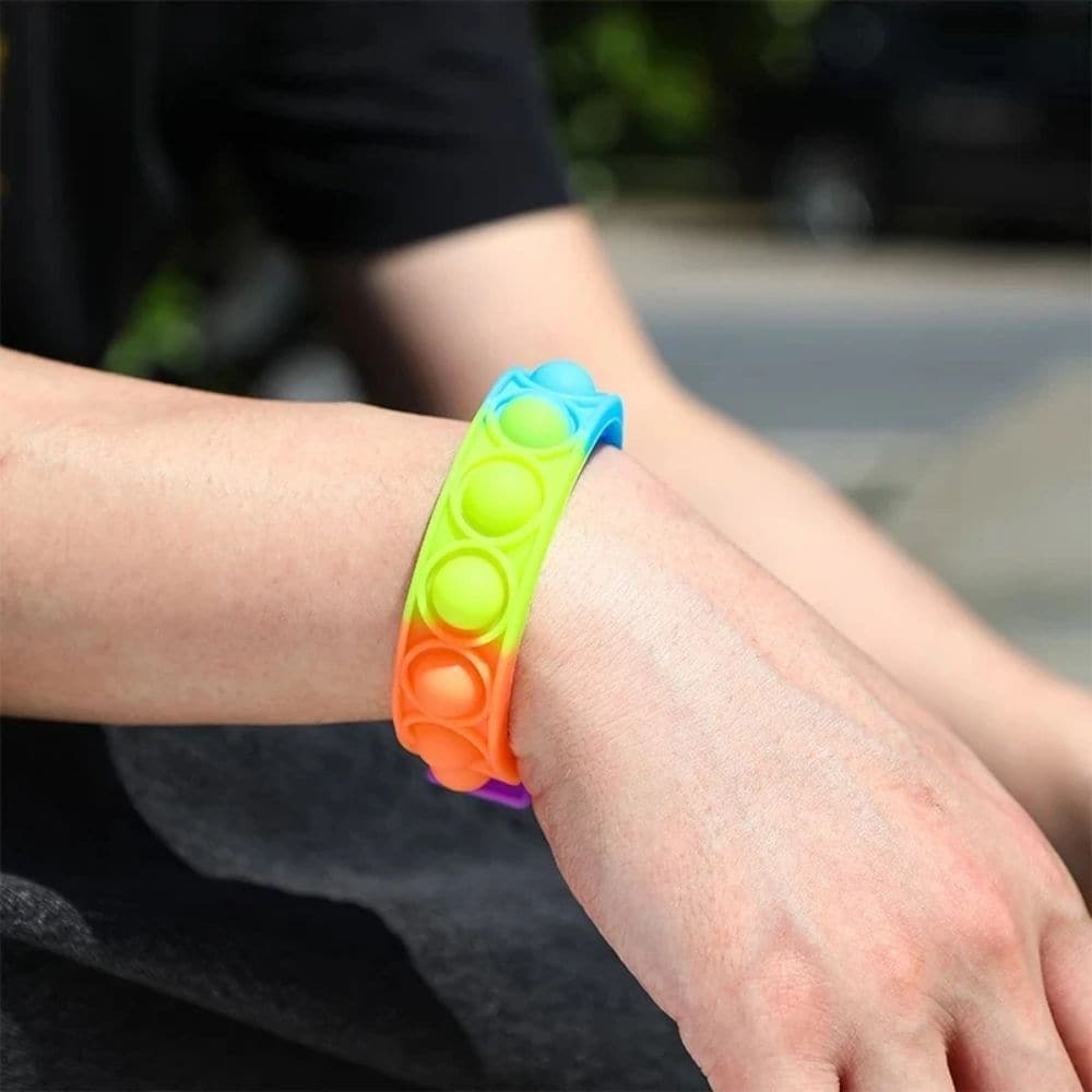 Rainbow Fidget Wristband, Rainbow Fidget Wristband,Fidget Bubble Popper,bubble popping toy,fidget toy bubble popping popper,fidget toys, Rainbow Fidget Wristband,Introducing the Rainbow Fidget Wristband, the ultimate sensory tool that will keep you entertained and relaxed for hours on end. If you've ever found joy in popping bubble wrap, then this is the perfect gadget for you. This wristband is designed to divert a busy mind, providing a therapeutic experience that helpsIntroducing the Rainbow Fidget Wrist