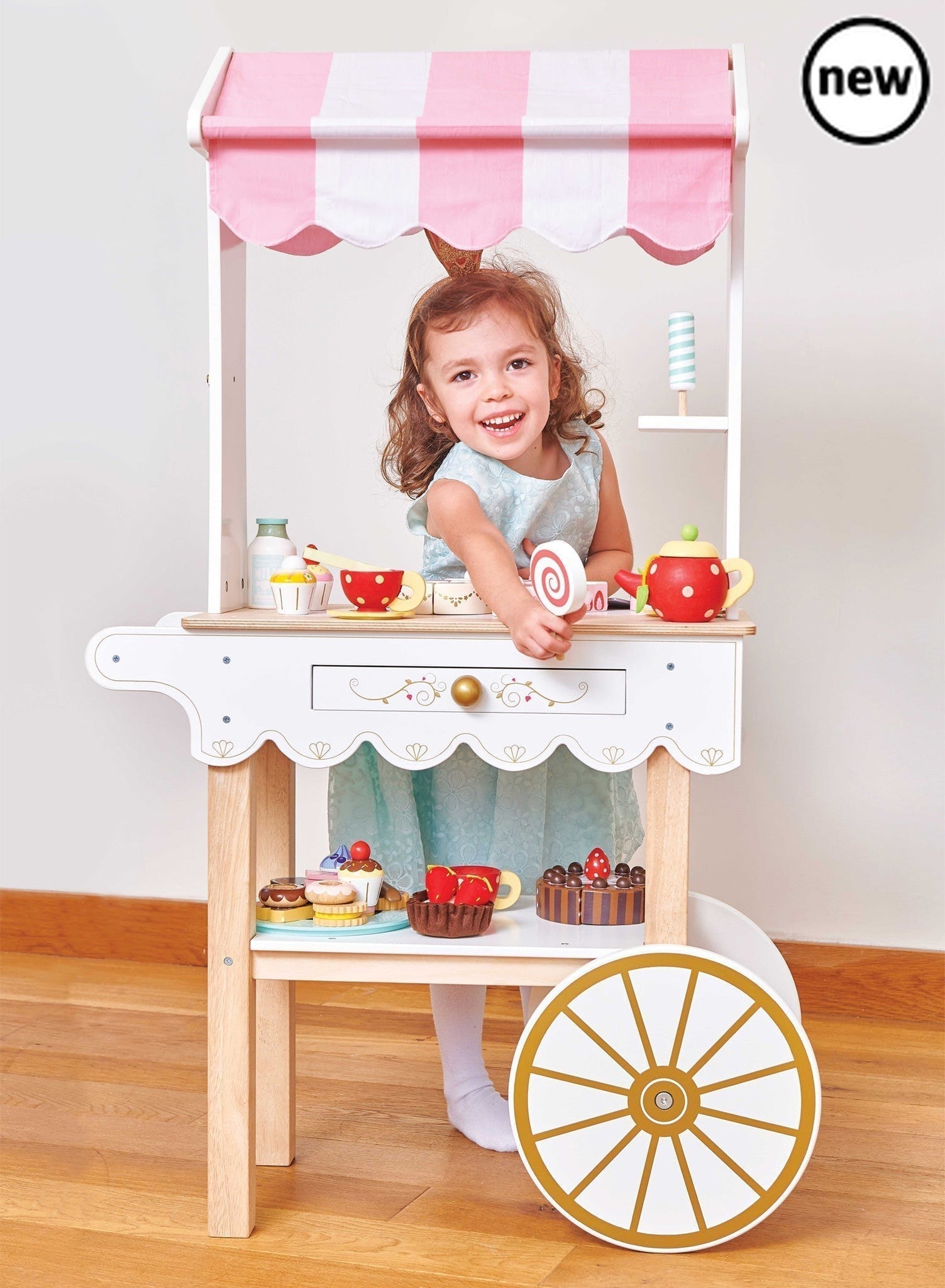 Tea & Treats Trolley, , Tea & Treats Trolley,Description Time for Tea! This barrow style tea and treats trolley is a real head turner. It's stunning vintage style design makes it a real showstopper and a truly magical gift to treasure. The traditional candy striped fabric canopy really sets off this beautiful wooden toy. Complete with a secret drawer ,this classi,Tea & Treats TrolleyDescription Time for Tea! This barrow style tea and treats trolley is a real head turner. It's stunning vintage style design m