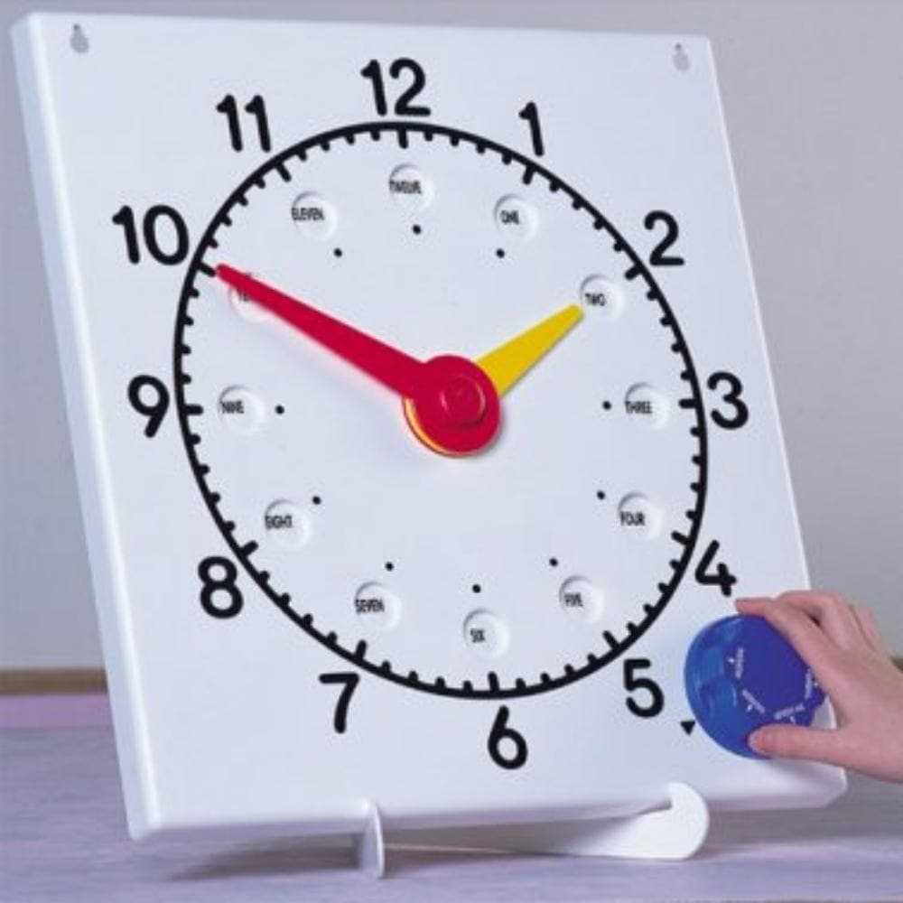 Teaching Clock, Teaching Clock English,Invicta teaching clock,Morleys teaching resources,handson learning resources, Teaching Clock,By turning the dial on the Teaching Clock, 6 alternative faces appear: 24 hour, roman numerals, minutes, words, fractions - and there is even a blank space to write on! The internally-sprung hands on the Teaching Clock move independently so that time before and after the hour can be shown without the hour hand moving. Teaching ClockBy turning the dial on the Teaching Clock, 6 a