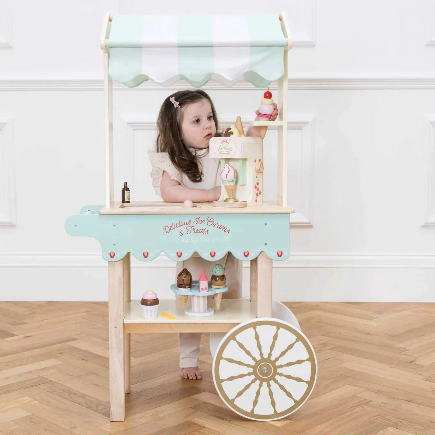 Ice Cream Trolley Market Stall, Ice Cream Trolley Market Stall,Le toy van,Pretend Play Toys,Role Play Toys,Christmas Toys, Ice Cream Trolley Market Stall – Sweet Treats & Classic Charm! Bring the joy of the fairground home with the Ice Cream Trolley Market Stall – a timeless wooden toy designed to spark imaginative play and inspire hours of creative fun. Crafted with a sprinkle of nostalgia, this stunning barrow-style trolley is the perfect addition to any playroom, encouraging role-play adventures filled w