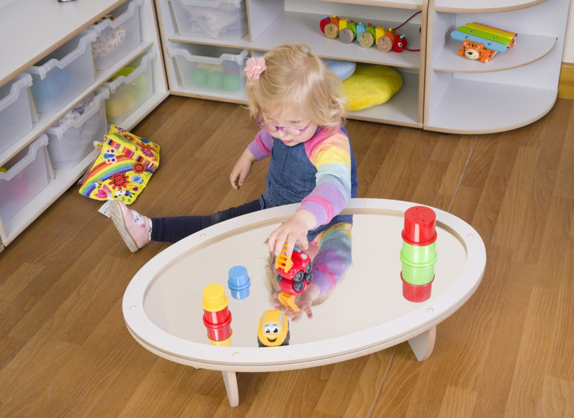 Low Oval Mirrored Table, Low Oval Mirrored Table,toddler mirror table,sensory mirror table,low oval mirror table, Low Oval Mirrored Table – A Safe & Engaging Space for Early Learning The Low Oval Mirrored Table is thoughtfully designed to provide a captivating and safe sensory experience for children under 3 years old. With its mirrored surface and child-friendly design, this table encourages early exploration, self-discovery, and sensory engagement, making it a valuable addition to nurseries, preschools, a