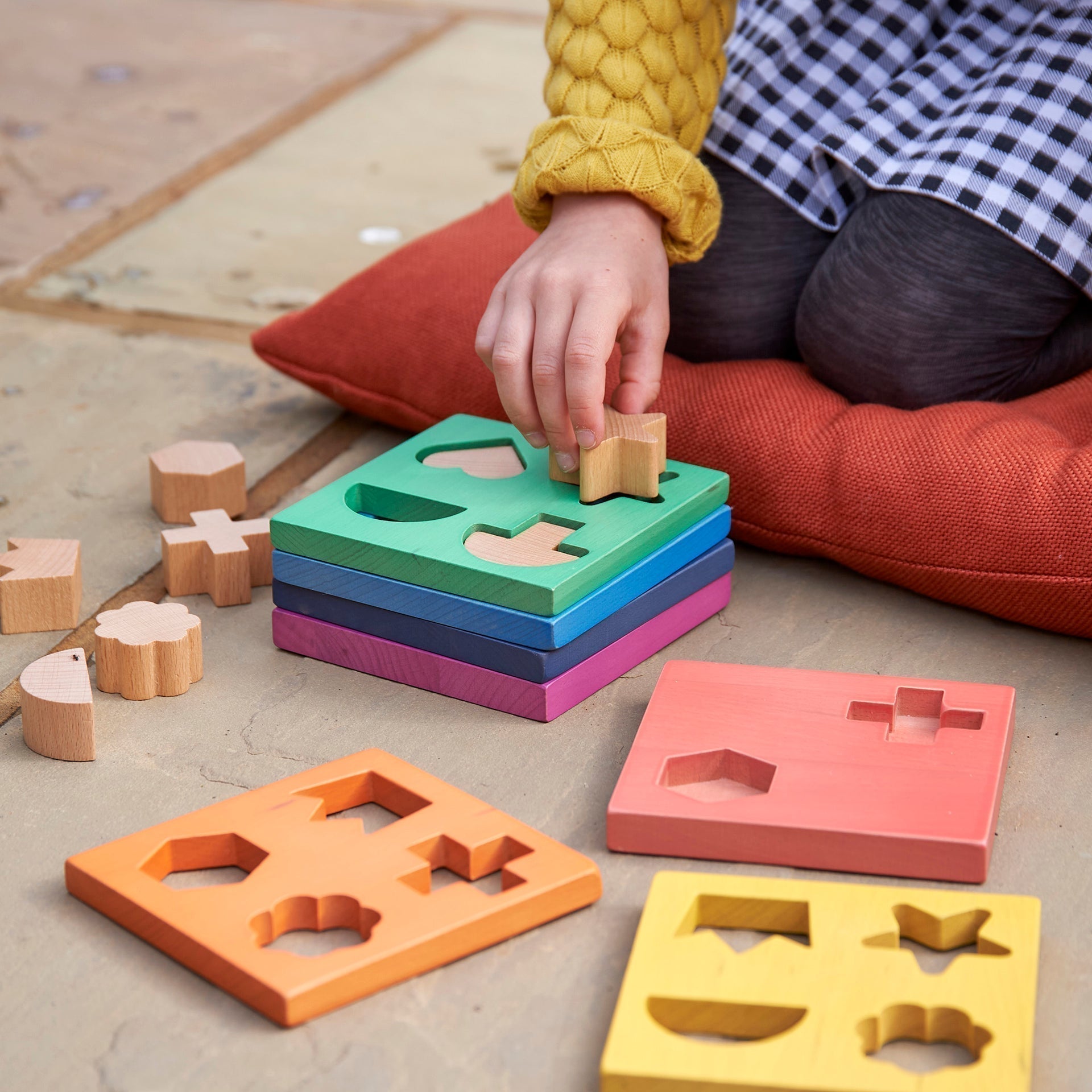 Rainbow Wooden Shape Stacker, Our TickiT® Rainbow Wooden Shape Stacker is a colourful and fun puzzle to help your child with shape recognition and problem solving skills. Made from beautiful smooth solid beechwood with a natural woodgrain finish in the 7 different colours of the rainbow. The 12 tactile shape cut outs nest inside a rounded square panel so your child can practice fitting them into their matching shaped hole or stack them to build a rainbow shape tower. The wooden panels are red, orange, yello