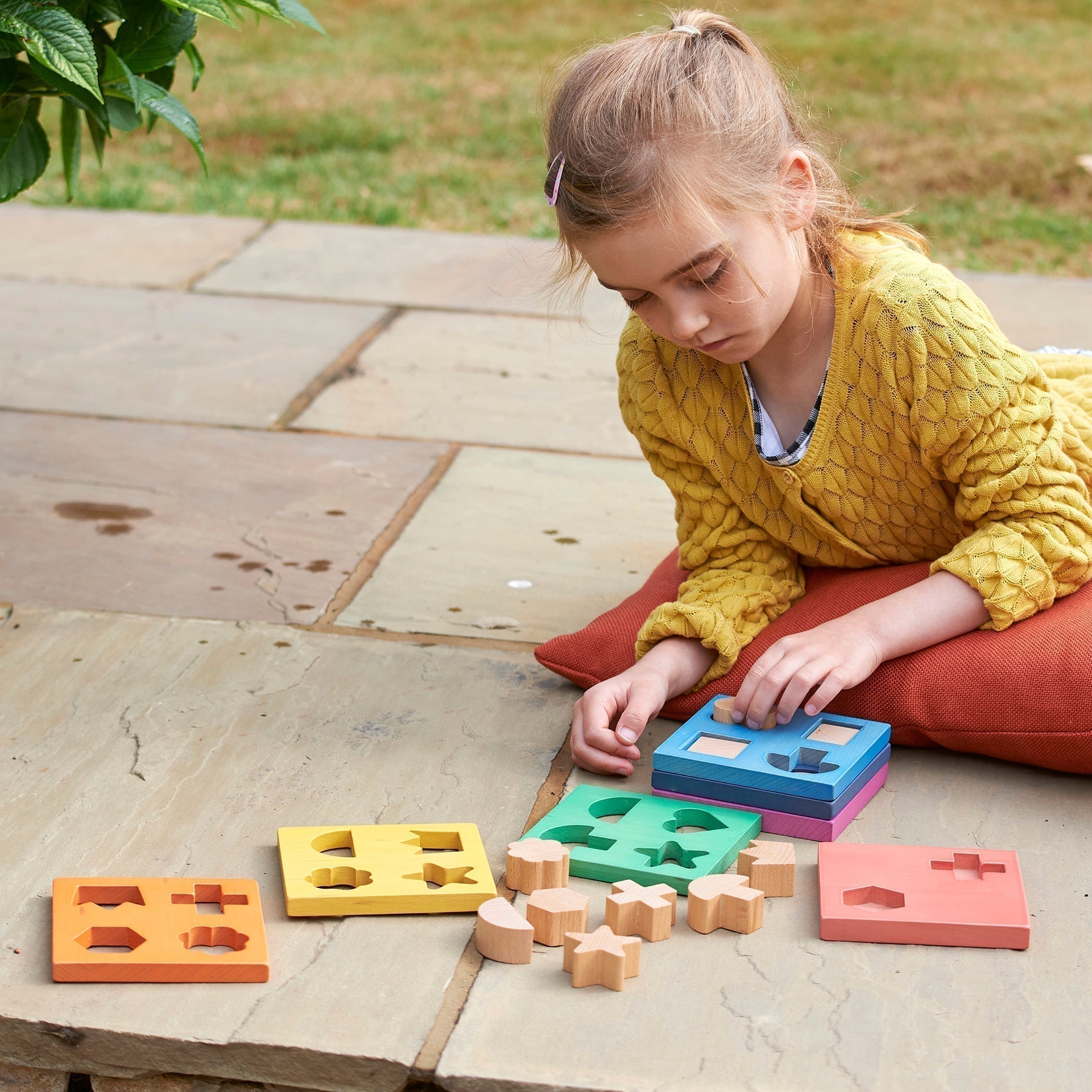 Rainbow Wooden Shape Stacker, Our TickiT® Rainbow Wooden Shape Stacker is a colourful and fun puzzle to help your child with shape recognition and problem solving skills. Made from beautiful smooth solid beechwood with a natural woodgrain finish in the 7 different colours of the rainbow. The 12 tactile shape cut outs nest inside a rounded square panel so your child can practice fitting them into their matching shaped hole or stack them to build a rainbow shape tower. The wooden panels are red, orange, yello