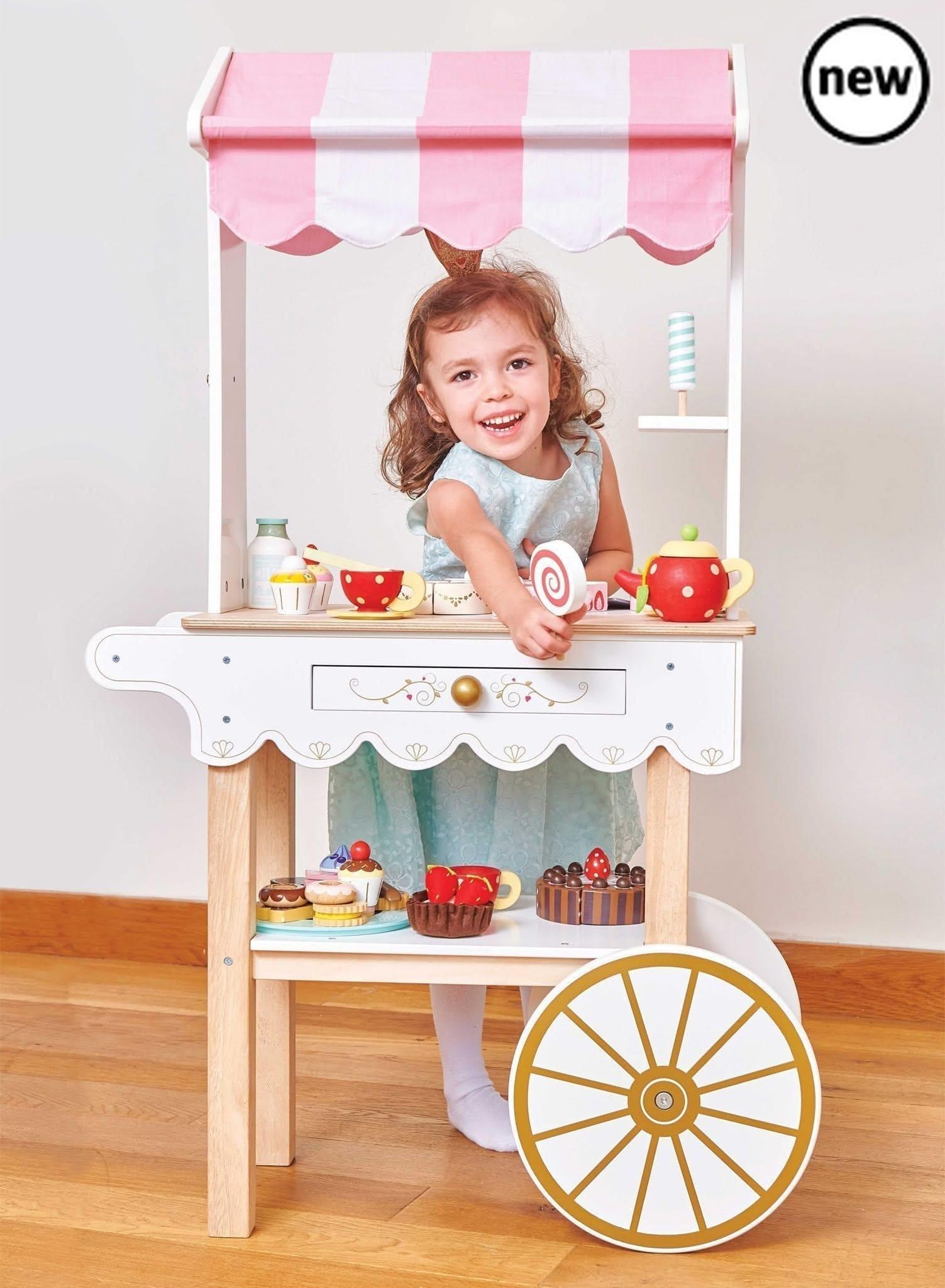 Tea & Treats Trolley, , Tea & Treats Trolley,Description Time for Tea! This barrow style tea and treats trolley is a real head turner. It's stunning vintage style design makes it a real showstopper and a truly magical gift to treasure. The traditional candy striped fabric canopy really sets off this beautiful wooden toy. Complete with a secret drawer ,this classi,Tea &Description Time for Tea! This barrow style tea and treats trolley is a real head turner. It's stunning vintage style design makes it a real 