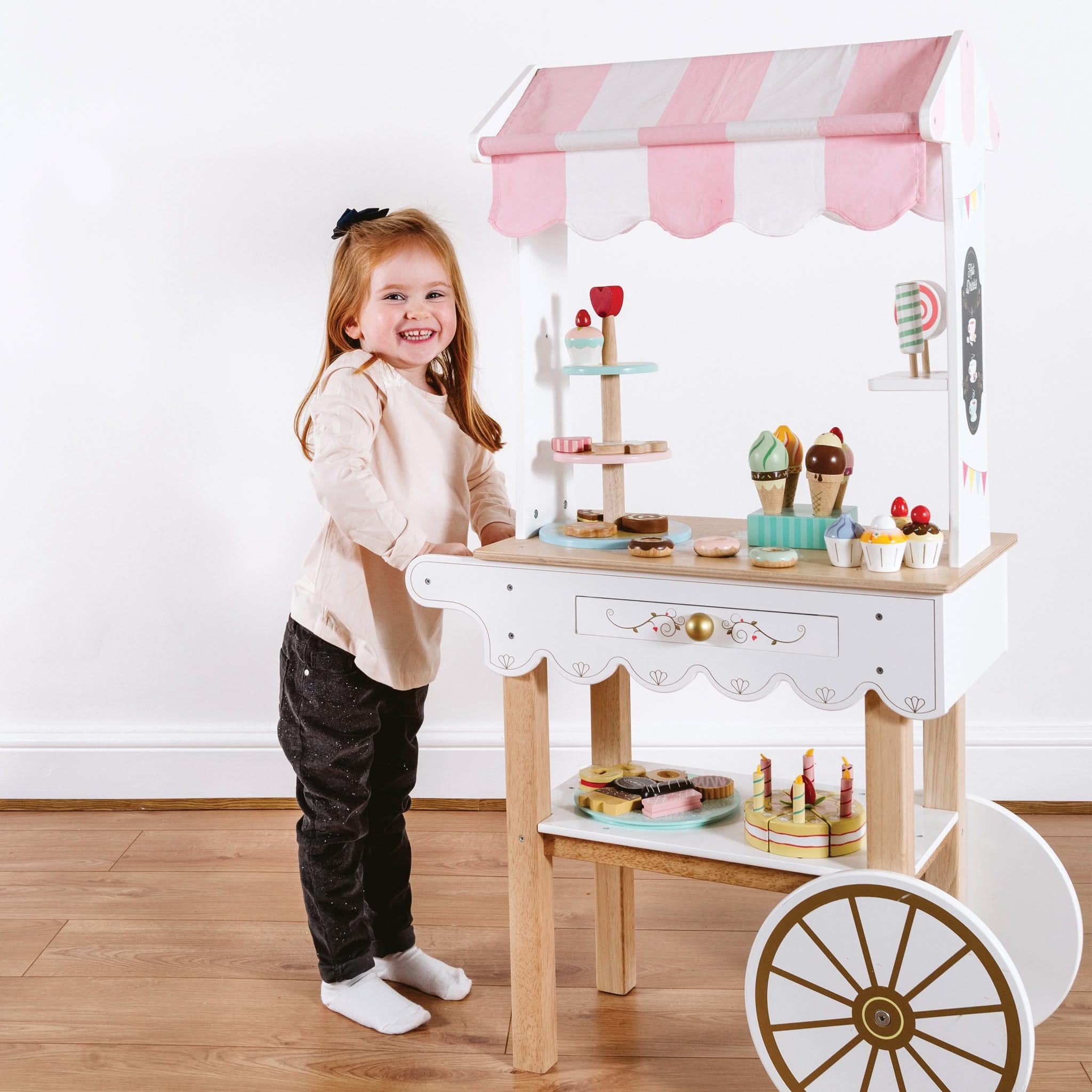 Tea & Treats Trolley Market Stall, Tea & Treats Trolley Market Stall,pretend play wooden kitchen,toddler kitchen,childrens kitchen toy, Tea & Treats Trolley Market Stall – A Delightful Afternoon Tea Adventure! Step into a world of elegance and charm with the Tea & Treats Trolley Market Stall, a beautifully designed wooden tea trolley that invites little hosts to serve up afternoon tea in style. With its vintage-inspired design, this timeless playset is a true showstopper, making it a magical gift to treasur