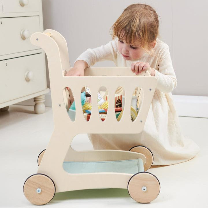 Tender Leaf Toys Shopping Cart, Tender Leaf Toys Shopping Cart,Shopping Trolley,Childrens shopping trolley,shopping trolley toy.kids shopping trolley, Tender Leaf Toys Shopping Cart – A Stylish Wooden Toy for Imaginative Play Bring the joy of shopping to life with the Tender Leaf Toys Shopping Cart, a beautifully designed wooden toy that inspires creativity and role play. Whether children are stocking up on essentials or exploring a make-believe supermarket, this charming shopping trolley is the perfect com