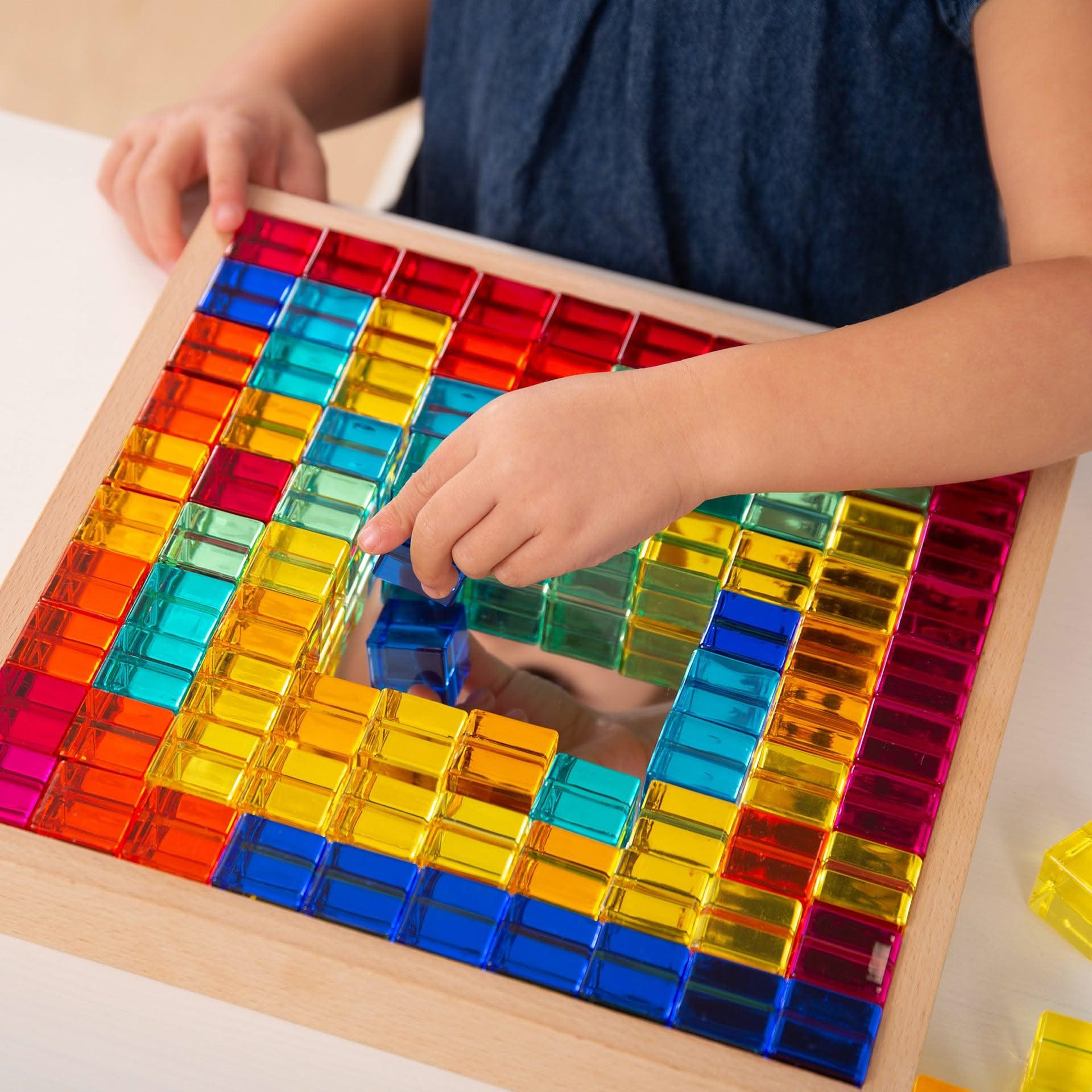 TickiT Gem Cube Mirror Tray, TickiT Gem Cube Mirror Tray,TickiT Toys,TickiT Resources,TickiT Mirror tray,TickiT mirrors, TickiT Gem Cube Mirror Tray,TickiT® Gem Cube Mirror Tray – A Colourful and Captivating Learning Tool for Young Minds Introduce your child to the joy of discovery and creative play with the TickiT® Gem Cube Mirror Tray. This beautifully designed set includes 100 sparkling gem cubes in a sturdy, high-quality beechwood tray, making it both anTickiT® Gem Cube Mirror Tray – A Colourful and Cap